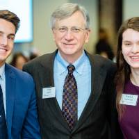 Two students posing with a donor at Scholarship Dinner 2019